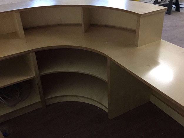 Curved plywood reception desk in progress