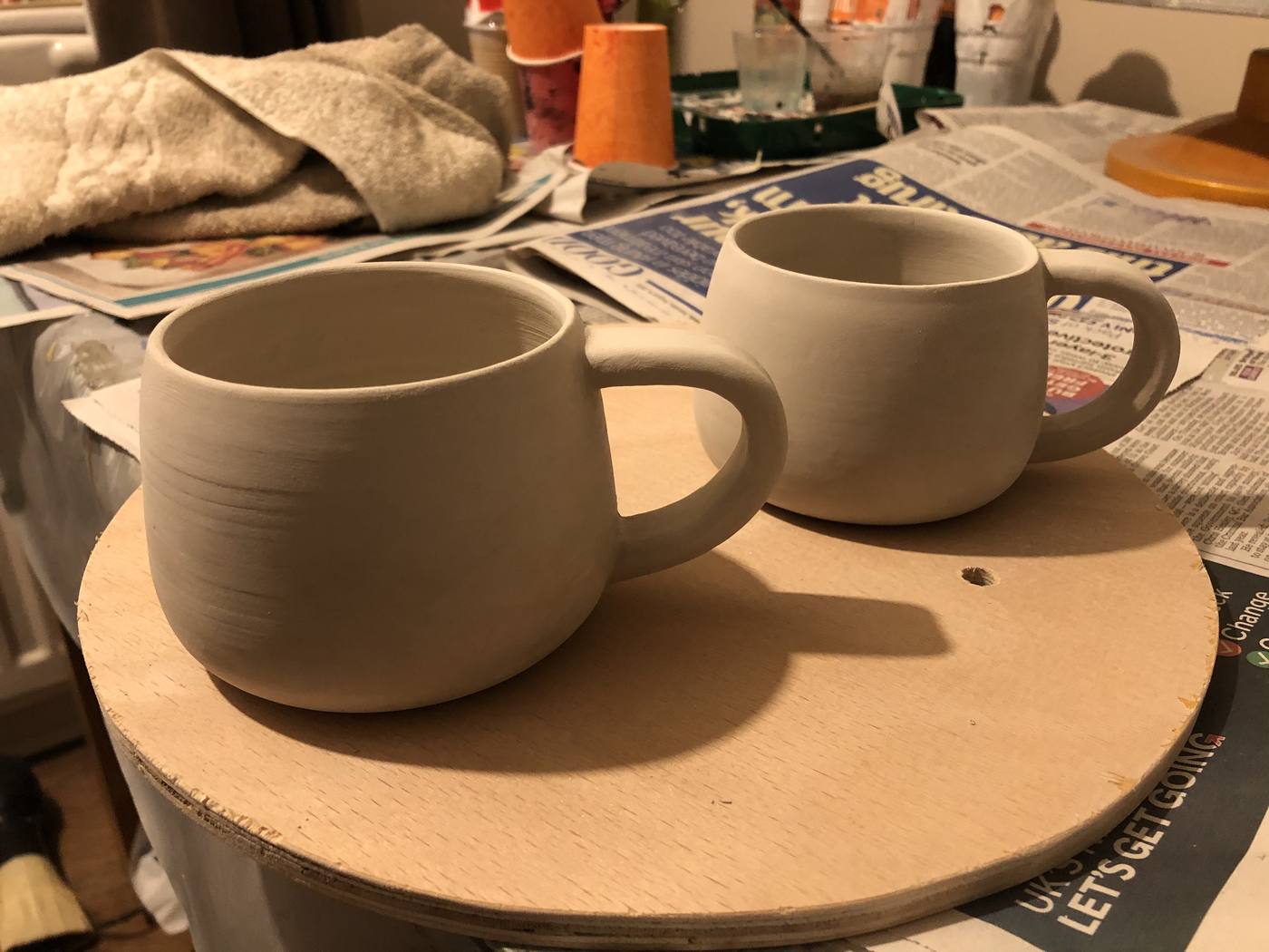 Two unfired clay mugs
